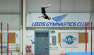 Farthest flip between horizontal bars